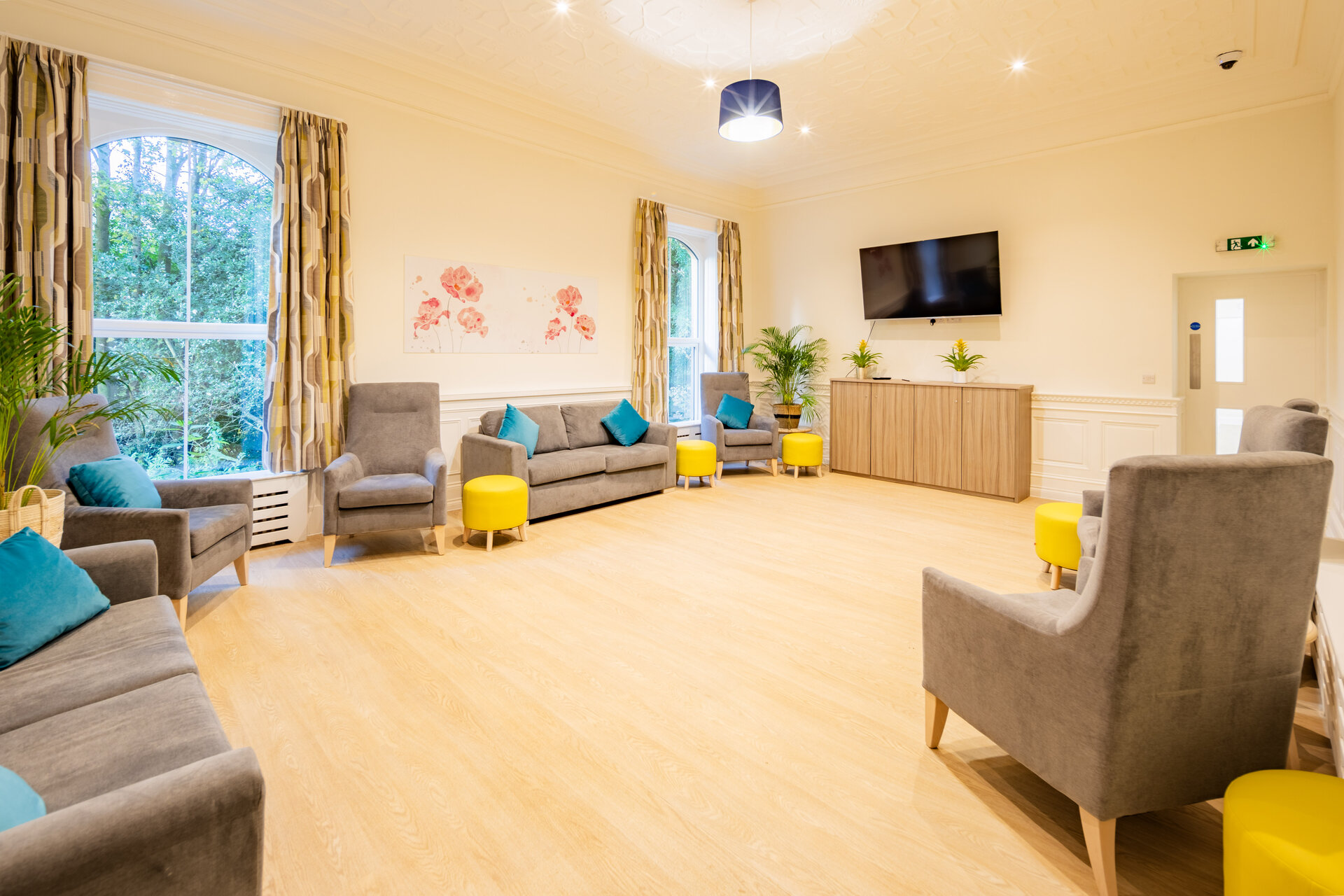 Communal living area with TV for service users at Castleholme Lodge